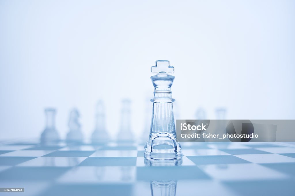 The true leadership. Photo of chess king standing in front of the same colour set in bright background. Achievement Stock Photo