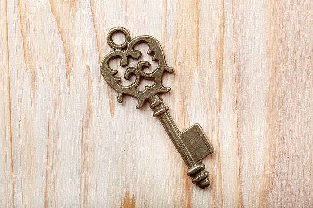 istock Old key on a wooden background 526707097