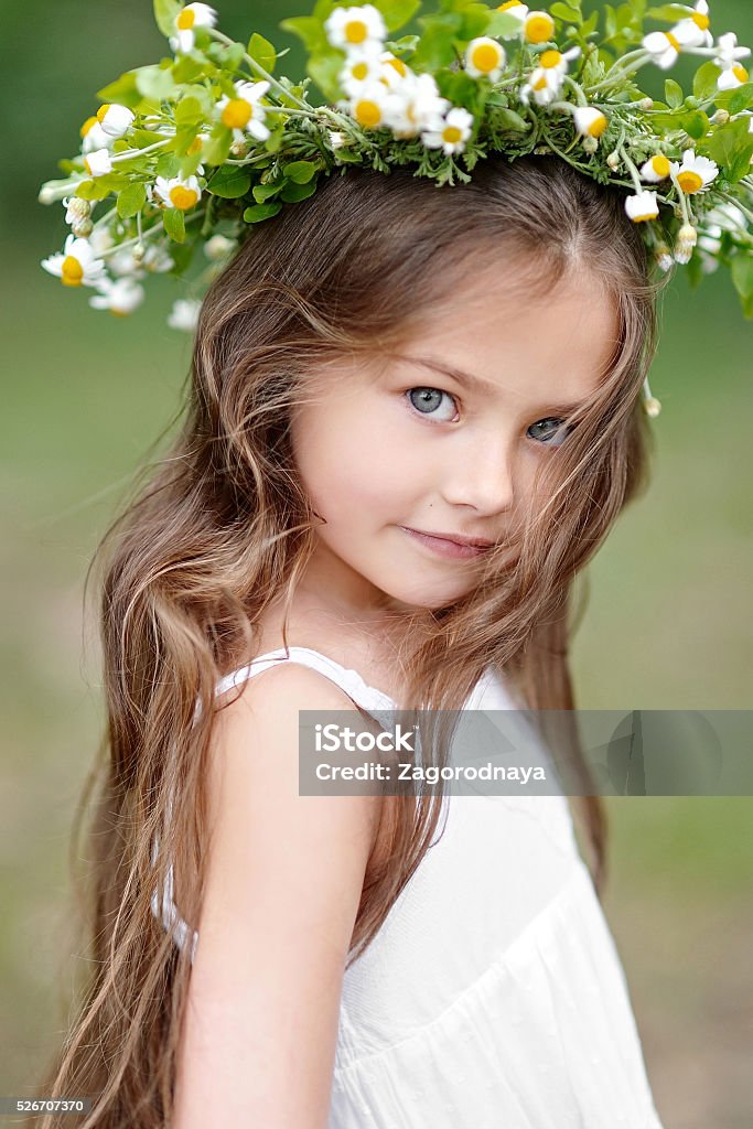 portrait of a beautiful little girl with flowers Baby - Human Age Stock Photo