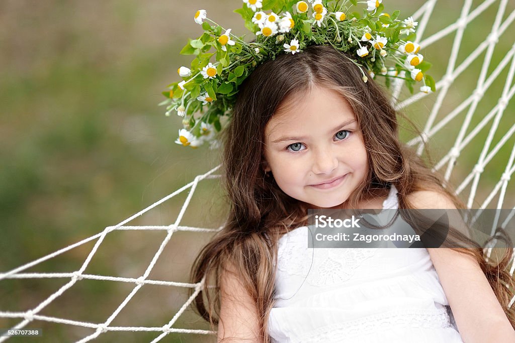 portrait of a beautiful little girl with flowers Baby - Human Age Stock Photo