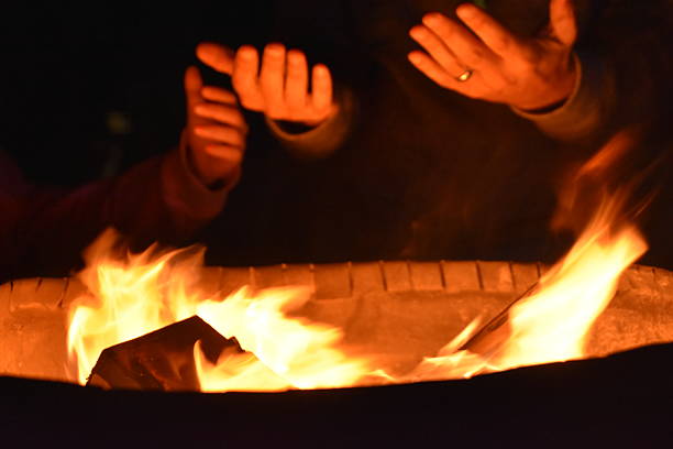 istock Homeless people warming hands by the  fire 526707588