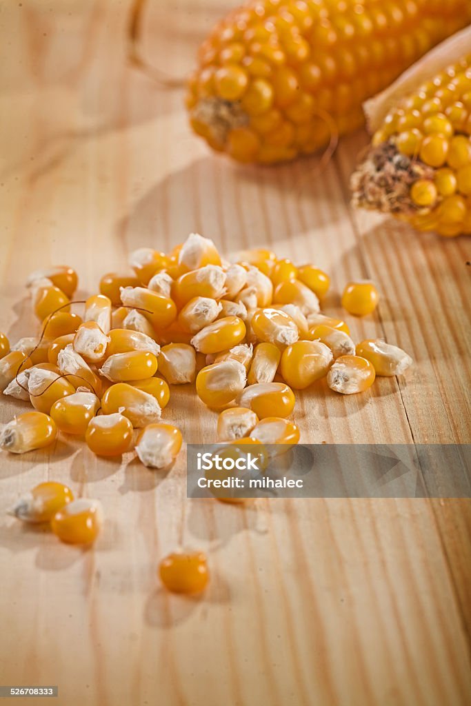 corn and ear of corns on wooden table Brown Stock Photo