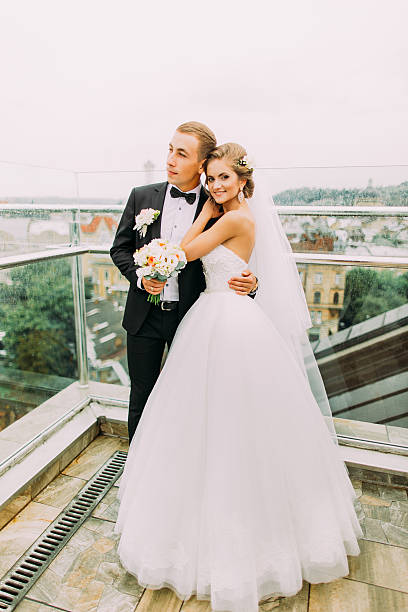 istock Happy bride and groom softly hugging on the terrace with 526711002