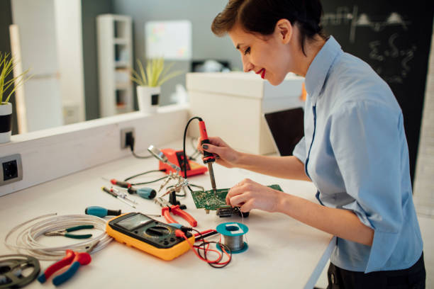 istock Woman Soldering a circuit board in her office. 526711556