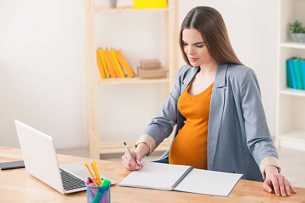 istock Cheerful pregnant lady is working in office 526712766