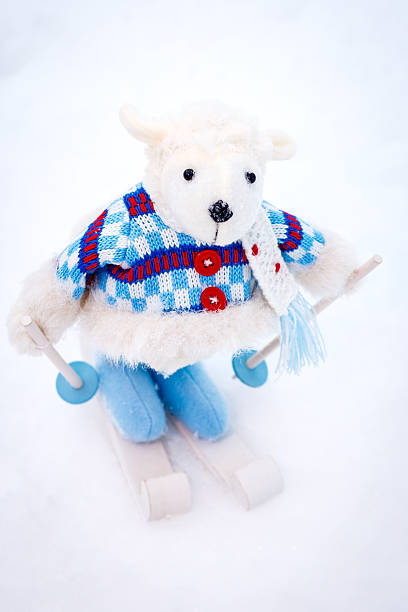 istock Fluffy cute soft toy sheep skiing 526713292