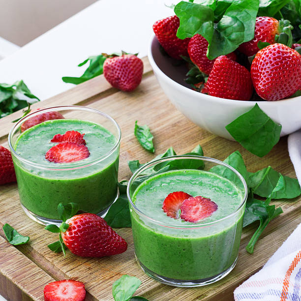 Green spinach smoothie with strawberry