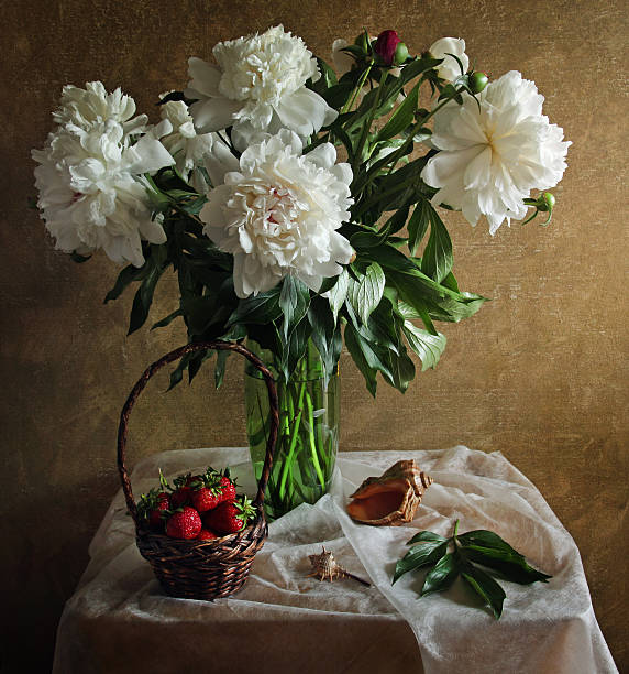 istock Still life with peonies strawberries and sea shell 526713916