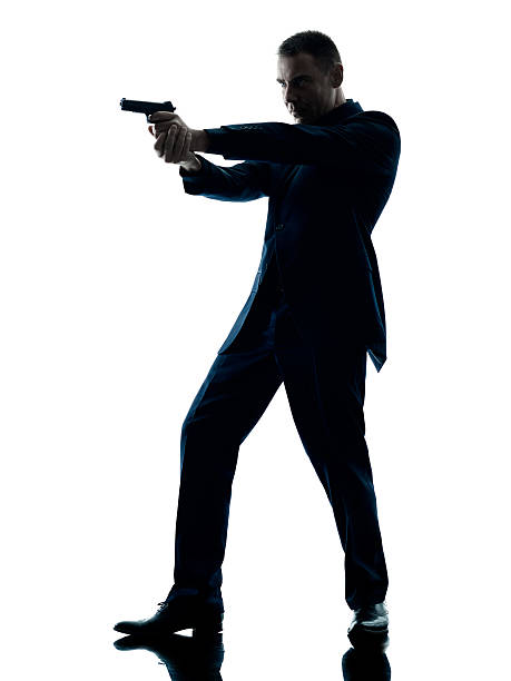 istock man with a handgun silhouette isolated 526714770