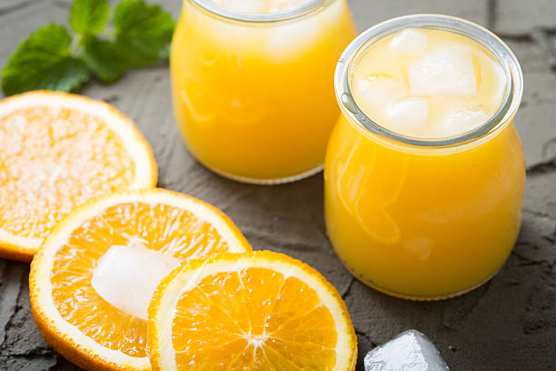 istock Orange juice in glass with mint, fresh fruits. selective focus, 526715176