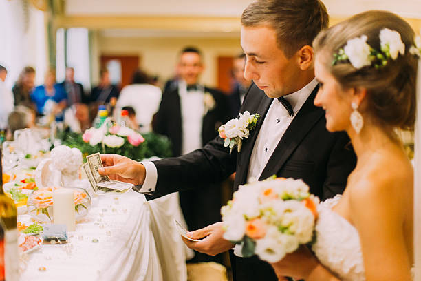 istock Handsome groom holding redemption of bride on wedding indoors 526715432