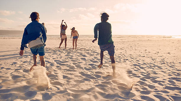 istock Friends running a race on the beach 526715670