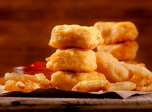 Chicken Nuggets with French Fries and BBQ Sauce Dip Chicken Nuggets with French Fries and BBQ Sauce Dip - Photographed on Hasselblad H3D2-39mb Camera nuggets heat stock pictures, royalty-free photos & images