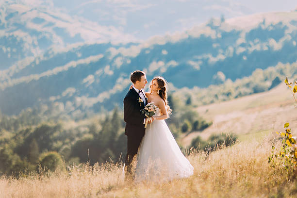 istock The bride and groom are standing in the meadow alone 526716648