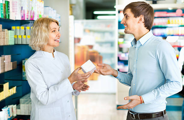 istock Female pharmacist counseling customer about drugs usage 526717420