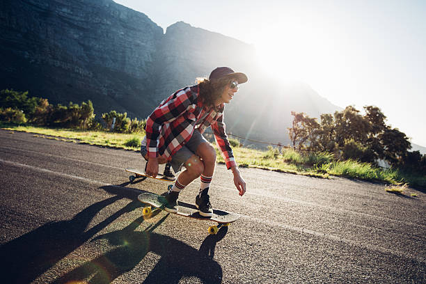 istock Man longboarding outdoors on countryside road 526717732