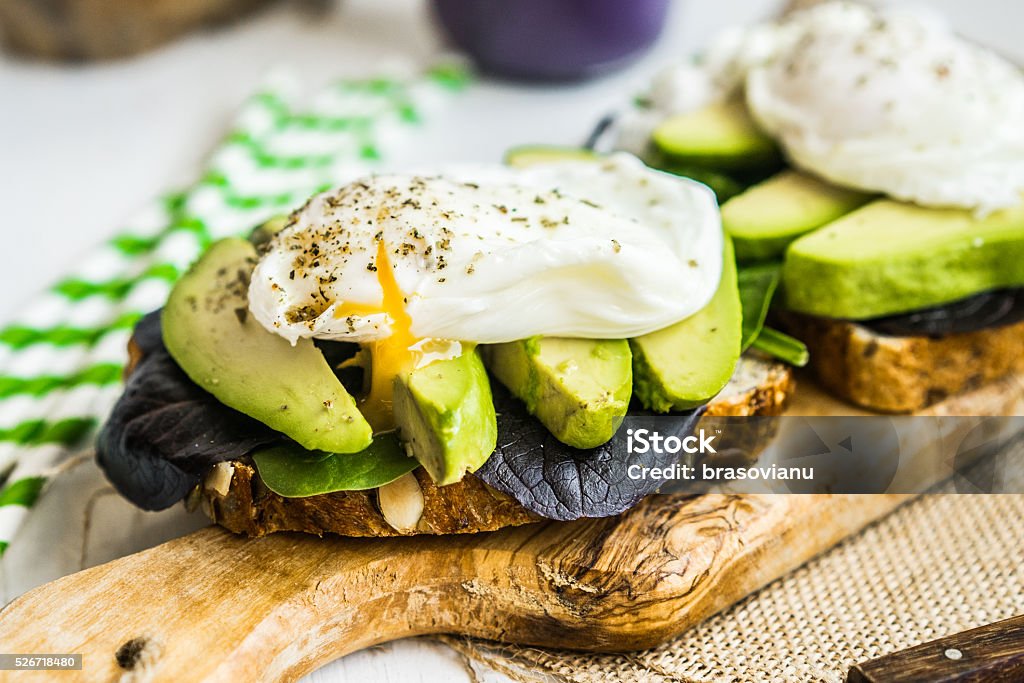 Healthy sandwich with avocado and poached eggs Avocado Stock Photo