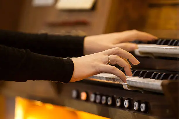 Photo of Hands of a woman playing the organ