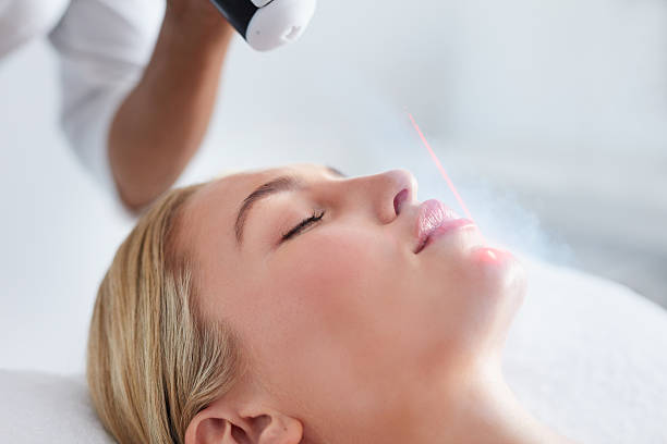 Young woman receiving local cryotherapy on her face Close up of face of young woman receiving local cryotherapy. Beauty treatment using vaporized nitrogen. medical laser photos stock pictures, royalty-free photos & images