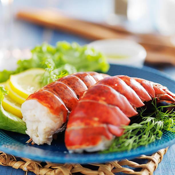 lobster dinner with lemon and lettuce lobster dinner with lemon and lettuce for a garnish tail fin photos stock pictures, royalty-free photos & images