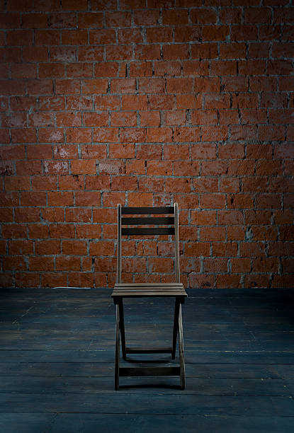 istock Chair and old brick wall 526721757