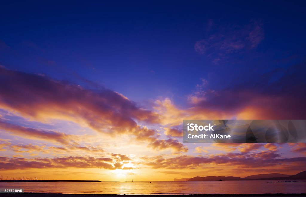 colorful sunset over Capo Caccia scenic sunset over the sea in Alghero, Sardinia Alghero Stock Photo