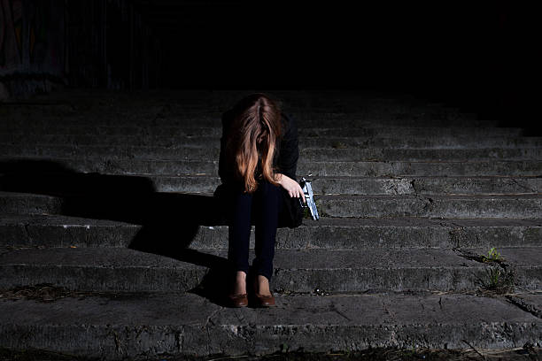 istock Woman with gun in the darkness 526721907