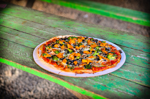 Pizza veggie topping on a green table