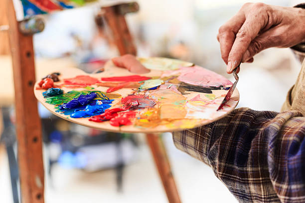 istock Close up of fine art painter's hand working at workshop 526724222