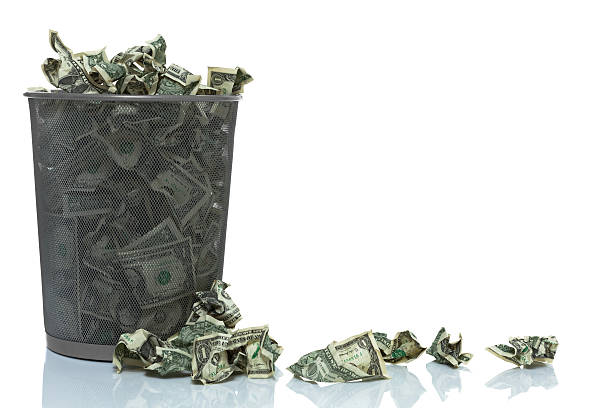 istock Garbage can full of money spilling over 526724495