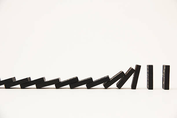 istock Falling line of dominoes 526724529