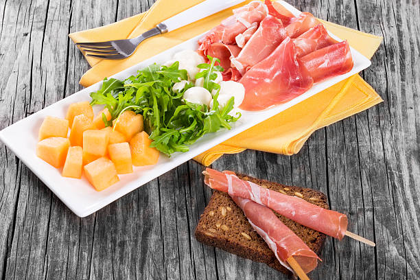 istock Arugula, prosciutto, mozzarella and melon  salad , close up 526725590