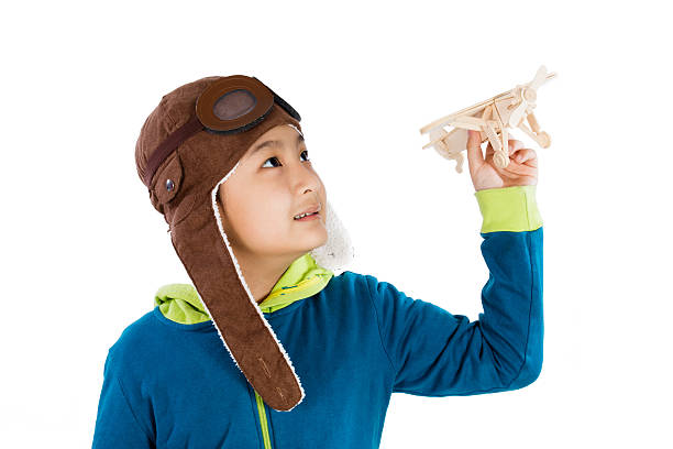 istock Asian Chinese Boy Playing with Wooden Airplane 526725848