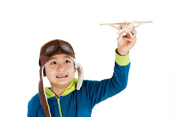 istock Asian Chinese Boy Playing with Wooden Airplane 526725934