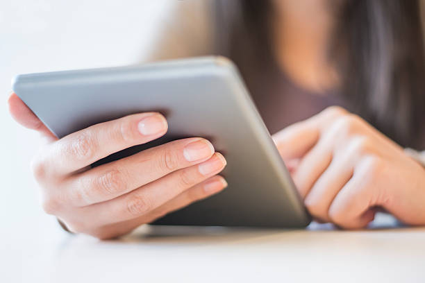 istock Woman reading an article on her tablet 526727141