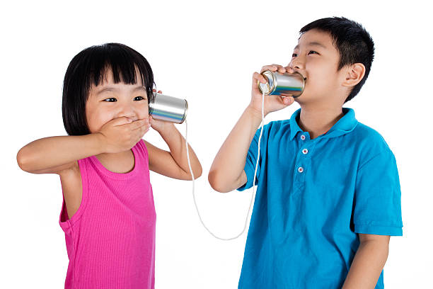 istock Asian Chinese Kid Playing with Tin Can Phone 526727586