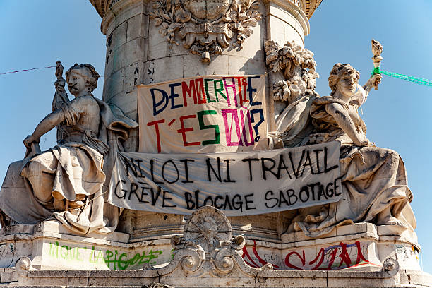 Paris, France - May 1, 2016: Banners against labour law on Statue Of the Republic of Place de la République. The french text means on top banner \