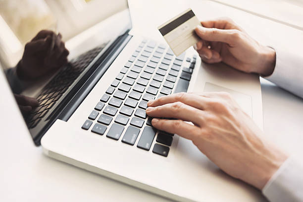 istock Man is shopping online with laptop 526728270