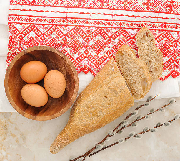 eggs in a wooden plate, bread pita and willow twigs