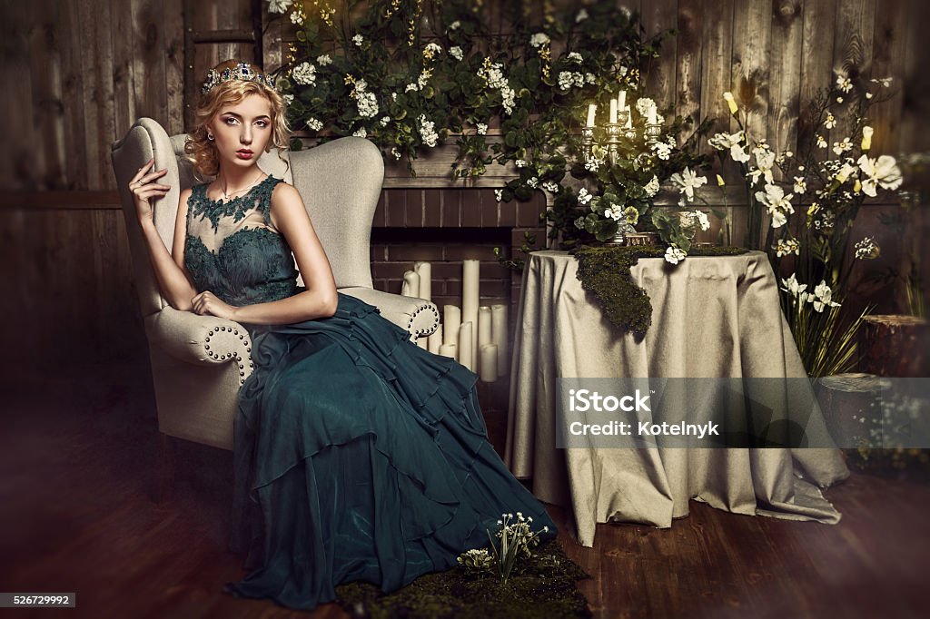 Young attractive bride with flowers Beautiful blond girl in a crown, professional evening make-up. Beauty face. Abstract Stock Photo