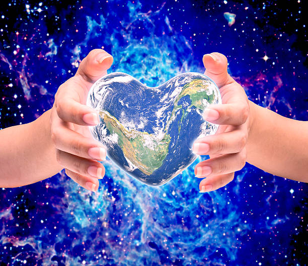 istock World in heart shape with over women human hands 526731432
