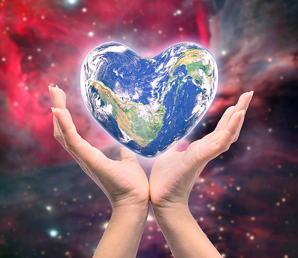 istock World in heart shape with over women human hands 526732578