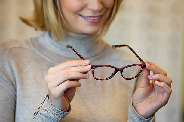 istock Young woman trying on glasses 526735370