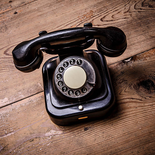 istock Old black phone with dust and scratches on white background 526735752