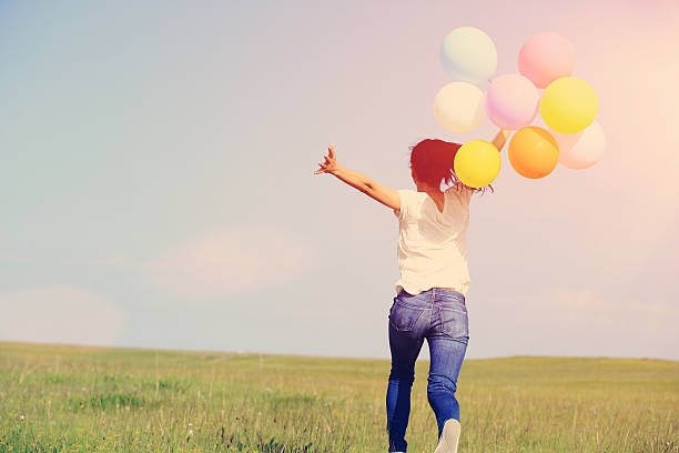 istock young asian woman  with colored balloons 526743337