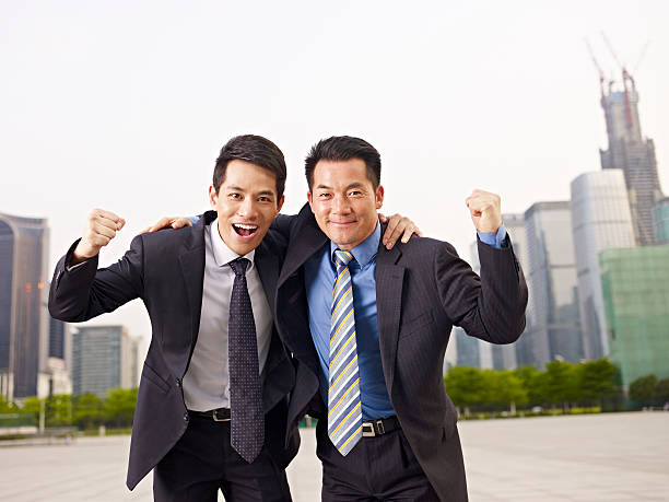 istock asian businessmen celebrating success 526743359