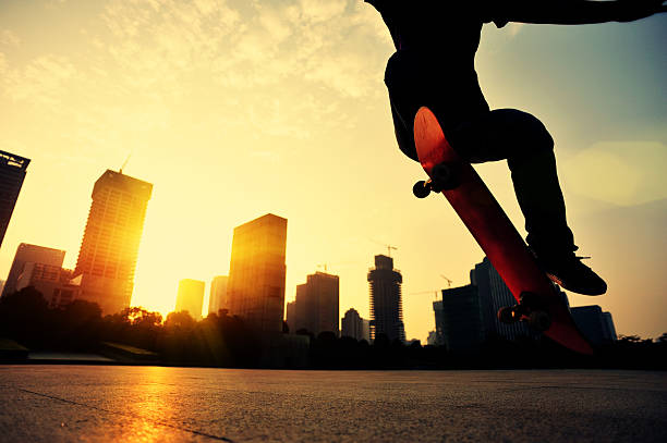 istock skateboarding woman jumping at  sunrise 526743579