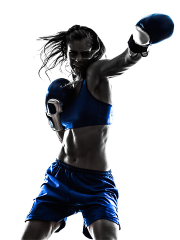 one woman boxer boxing kickboxing in silhouette isolated on white background