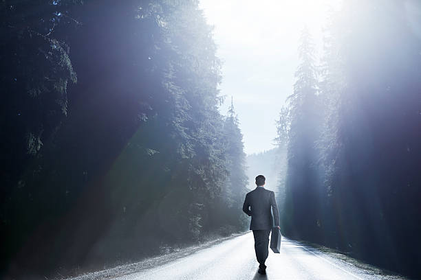 istock Businessman Walking Down Middle Of Road 526744913