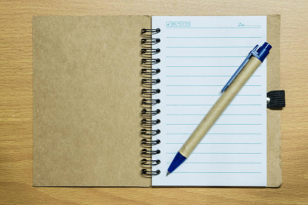 istock notebook and pen on wood floor 526747017